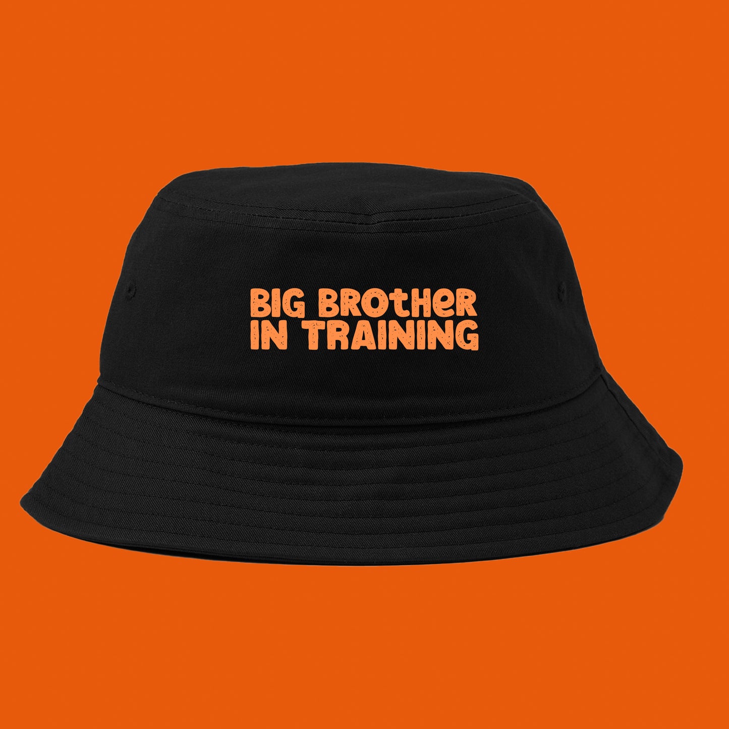 big brother in training orange bucket hat